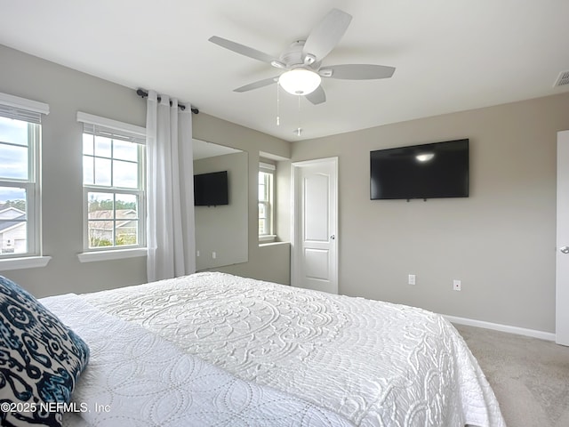 carpeted bedroom featuring visible vents, ceiling fan, and baseboards