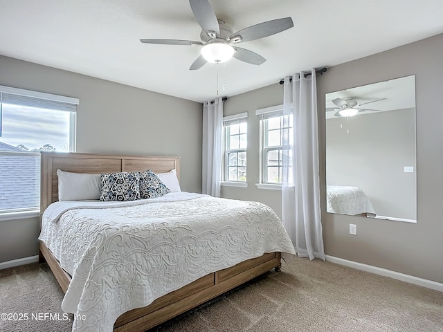 bedroom featuring carpet floors, multiple windows, and baseboards