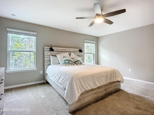 bedroom featuring ceiling fan, carpet flooring, and baseboards