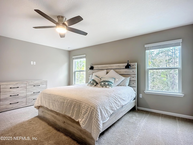 carpeted bedroom featuring ceiling fan and baseboards