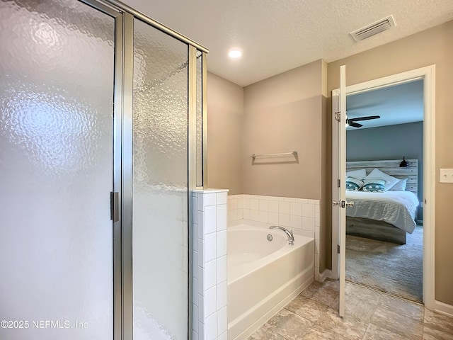 ensuite bathroom featuring a stall shower, visible vents, ensuite bath, a garden tub, and a textured ceiling