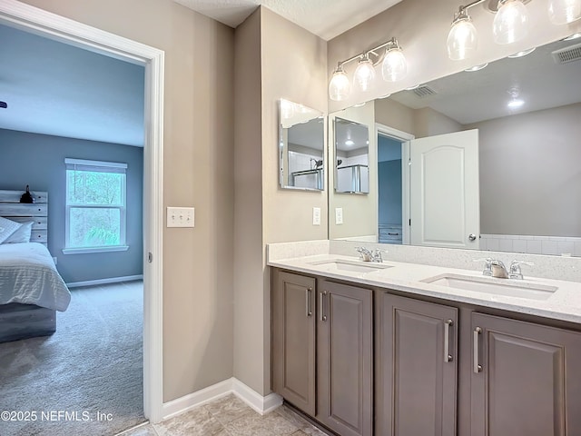 full bath with connected bathroom, visible vents, a sink, and double vanity