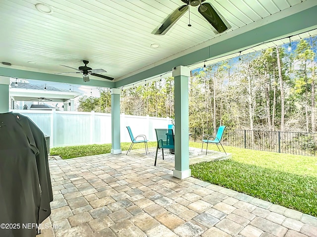 view of patio featuring a fenced backyard, grilling area, and a ceiling fan