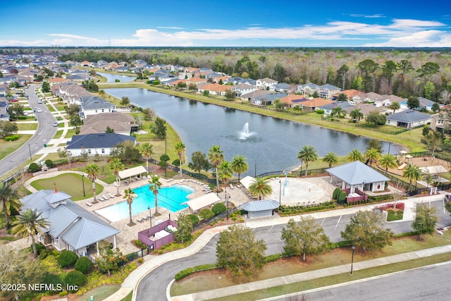 bird's eye view featuring a water view and a residential view