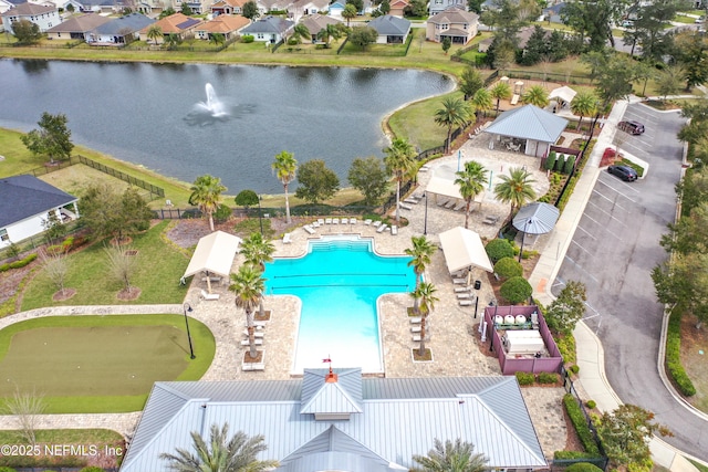 drone / aerial view with a water view and a residential view