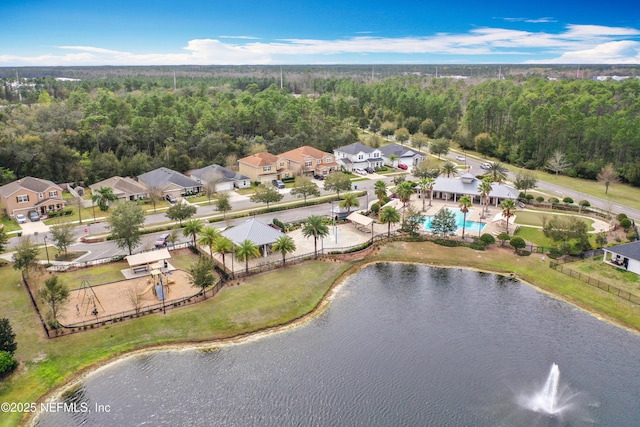 bird's eye view featuring a water view and a wooded view