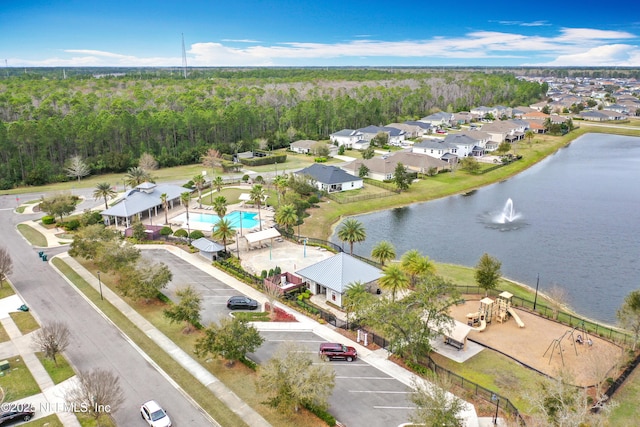 bird's eye view featuring a residential view, a water view, and a view of trees