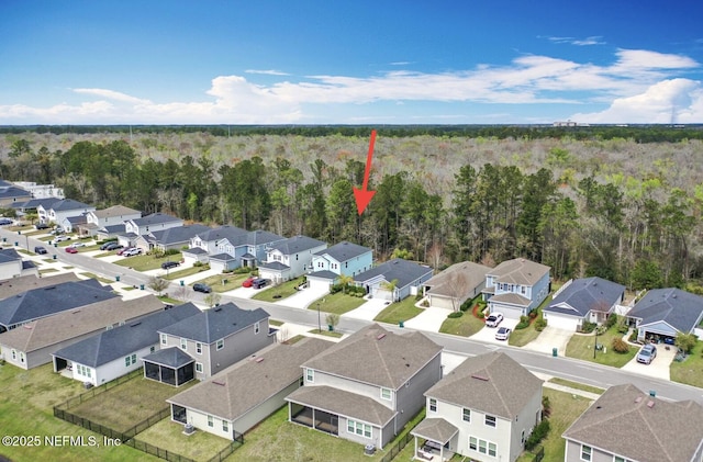 birds eye view of property featuring a residential view and a view of trees