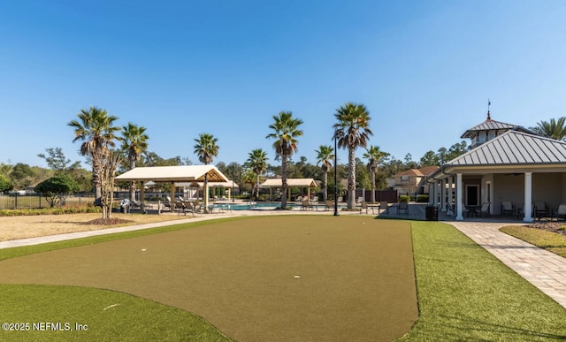 view of home's community with a pool and a patio area