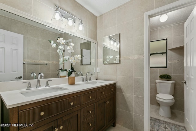 full bath with tile walls and a sink