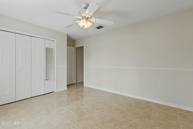 unfurnished bedroom featuring light tile patterned floors, baseboards, visible vents, and a closet