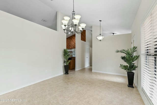 interior space with a high ceiling, visible vents, baseboards, and an inviting chandelier