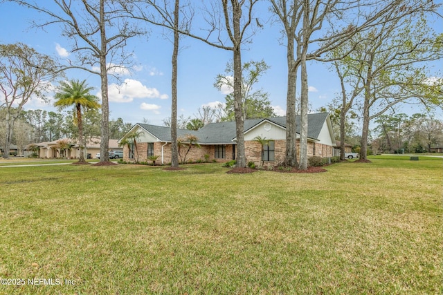 view of front of house with a front lawn and brick siding