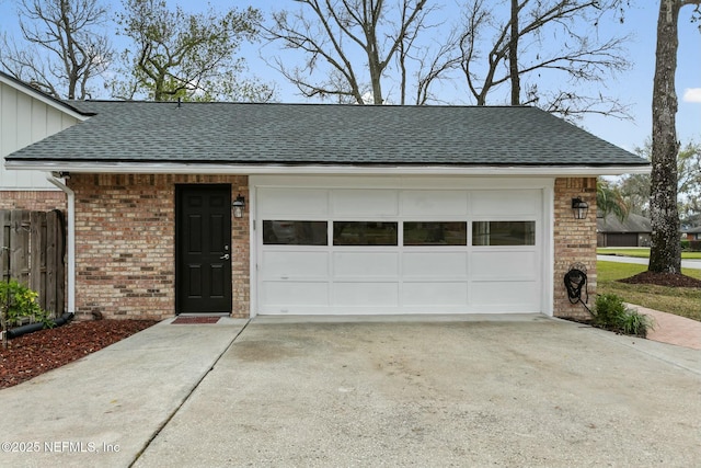 garage with driveway and fence