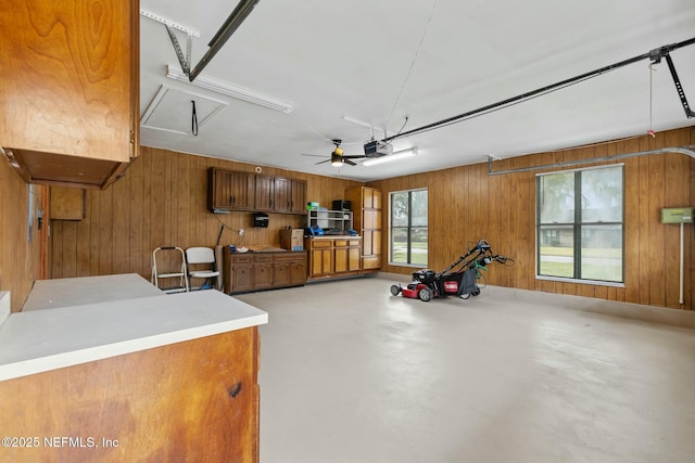 garage with wood walls and a garage door opener