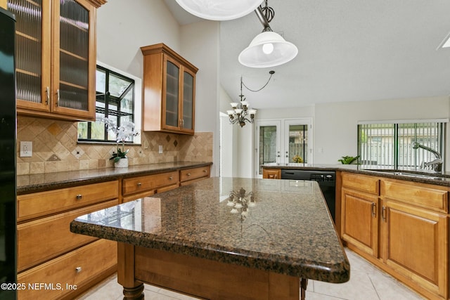 kitchen with a sink, vaulted ceiling, a center island, dishwasher, and brown cabinetry