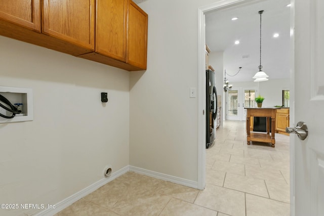 laundry area with washer hookup, french doors, light tile patterned floors, cabinet space, and baseboards