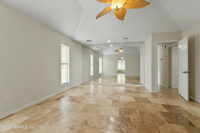 spare room with visible vents, ceiling fan, a textured ceiling, and baseboards