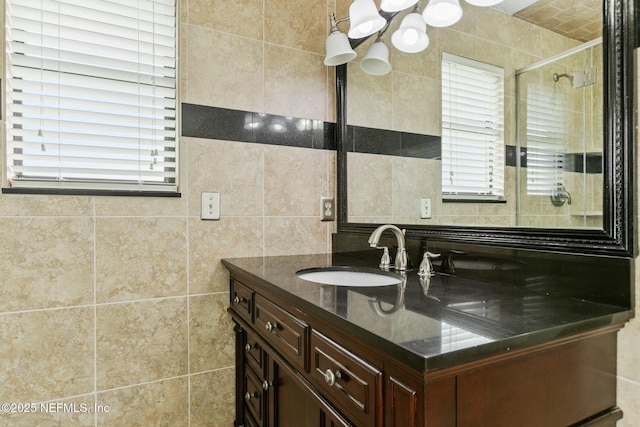 full bathroom featuring a stall shower, decorative backsplash, tile walls, and vanity