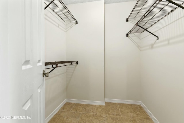 spacious closet with light tile patterned flooring