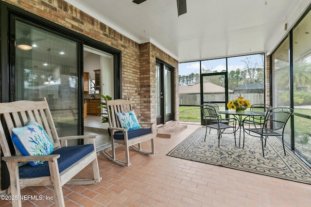 sunroom / solarium with a ceiling fan