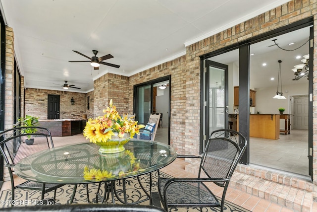 view of patio featuring a ceiling fan and outdoor dining area