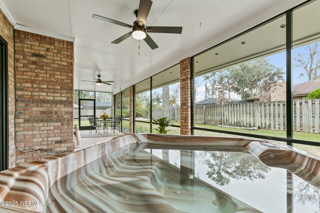 sunroom / solarium featuring a jacuzzi