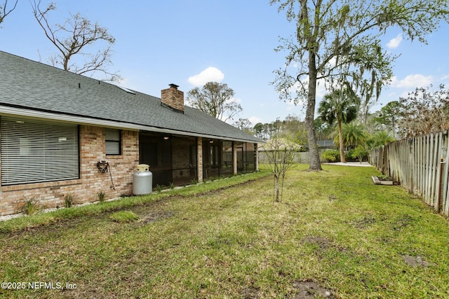 view of yard featuring a fenced backyard and a sunroom