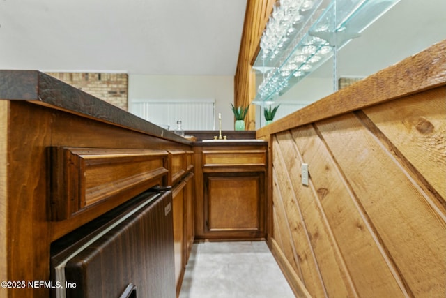 room details with dark countertops, brown cabinets, and radiator heating unit