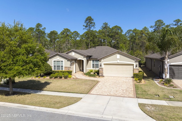 607 Caspia Ln, Ponte Vedra, FL 32081 - ranch-style home with driveway, a front yard, stone siding, stucco siding, and an attached garage