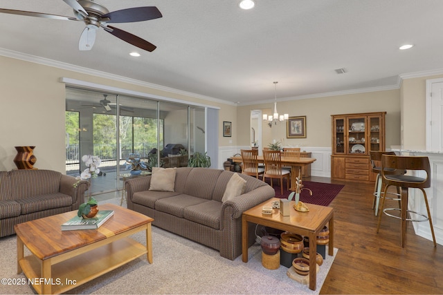 607 Caspia Ln, Ponte Vedra, FL 32081 - living room with ornamental molding, wood finished floors, ceiling fan with notable chandelier, and wainscoting