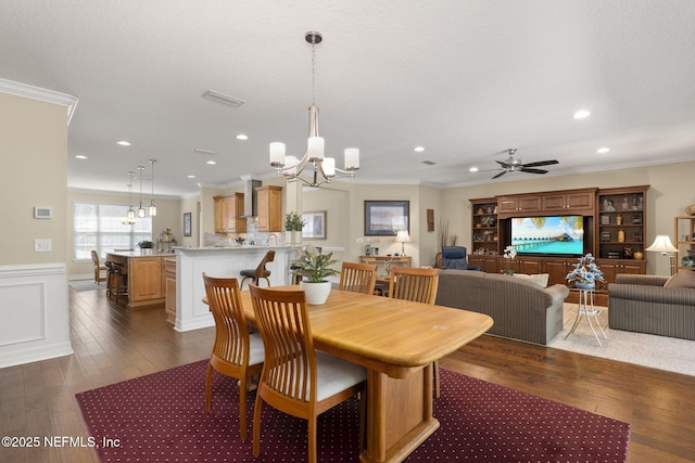 607 Caspia Ln, Ponte Vedra, FL 32081 - dining room featuring dark wood-type flooring, crown molding, and ceiling fan with notable chandelier