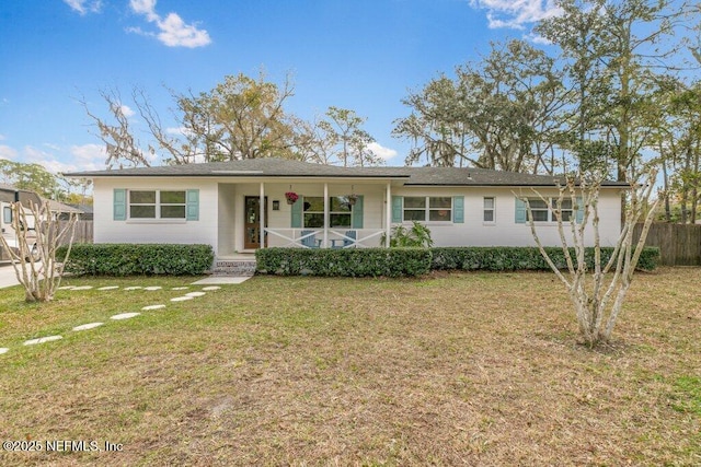 ranch-style house featuring covered porch, a front lawn, and fence