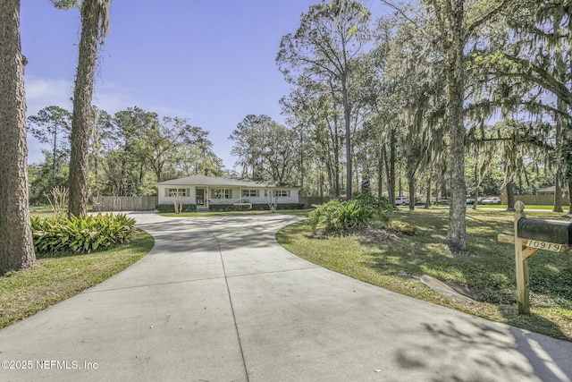 view of front of property with driveway and fence