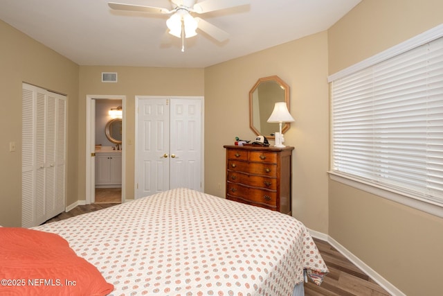 4020 Lavista Cir Unit 207, Jacksonville, FL 32217 - bedroom with baseboards, visible vents, ceiling fan, wood finished floors, and two closets