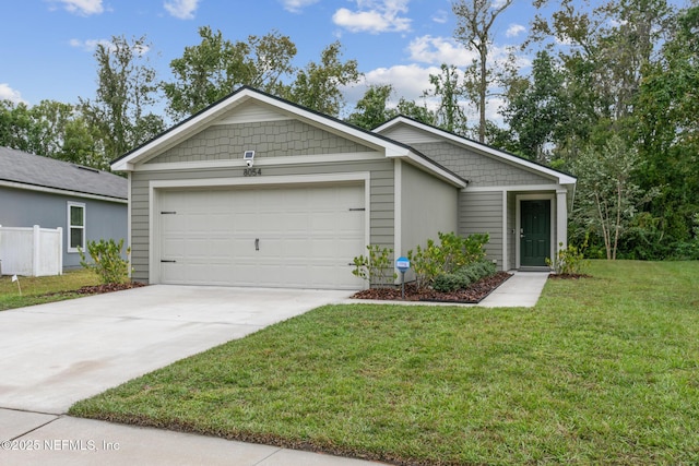 view of front of house with a garage, driveway, and a front yard