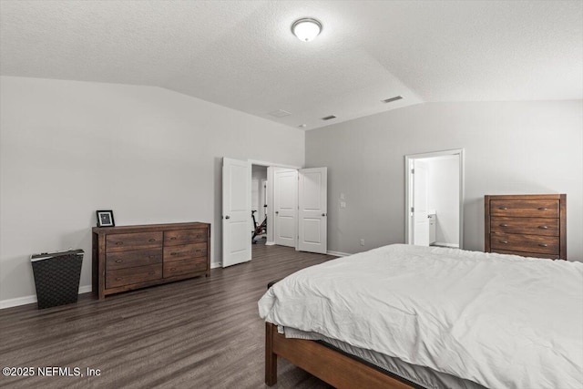 bedroom featuring dark wood-style floors, visible vents, vaulted ceiling, and baseboards