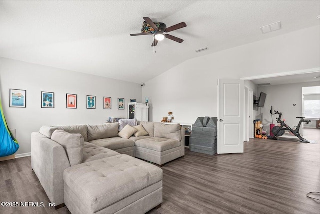 living area featuring visible vents, a ceiling fan, lofted ceiling, wood finished floors, and a textured ceiling