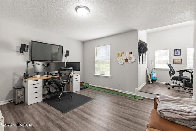 office featuring a textured ceiling, baseboards, and wood finished floors