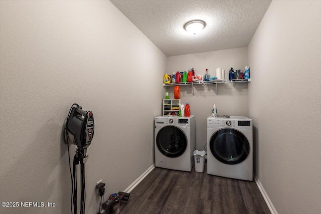 washroom featuring dark wood-style floors, washing machine and clothes dryer, a textured ceiling, laundry area, and baseboards