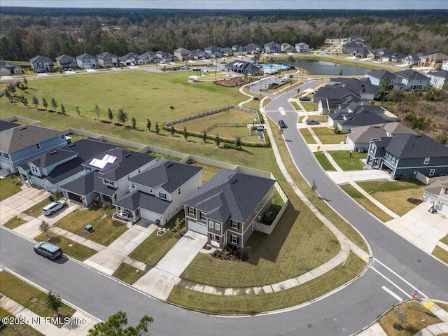 drone / aerial view featuring a water view and a residential view