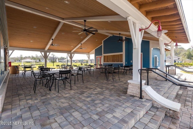 view of patio with outdoor dining area and ceiling fan