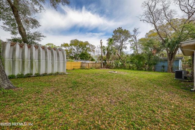 view of yard with cooling unit and fence