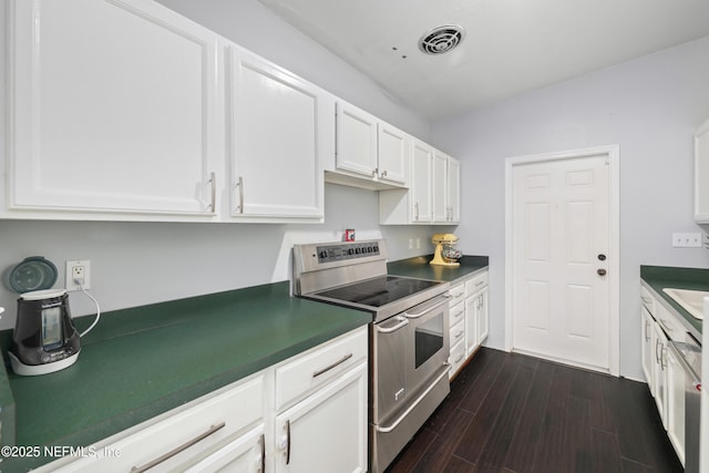 kitchen featuring visible vents, white cabinets, dark wood finished floors, dark countertops, and double oven range