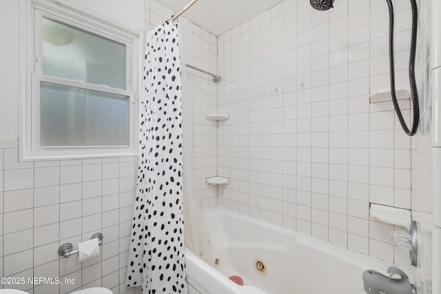 full bath featuring shower / tub combo and tile walls