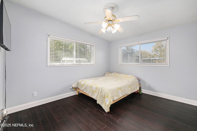 bedroom featuring baseboards and wood finished floors