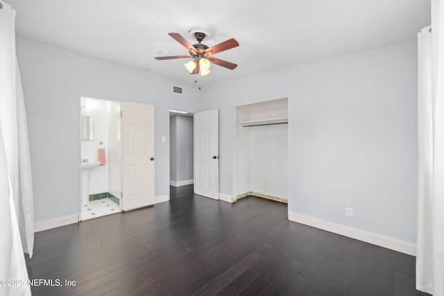 unfurnished bedroom featuring dark wood-type flooring, visible vents, and baseboards