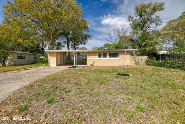 ranch-style house with a carport, a front yard, and driveway