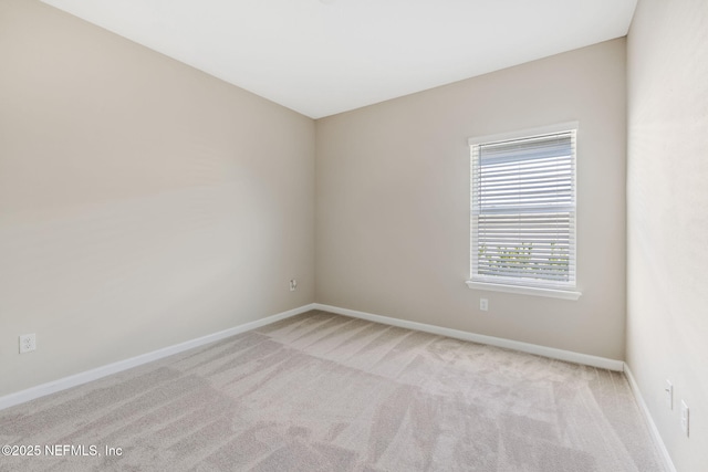 carpeted empty room with baseboards