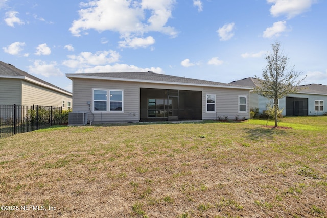 back of house featuring a sunroom, fence, central AC unit, and a lawn